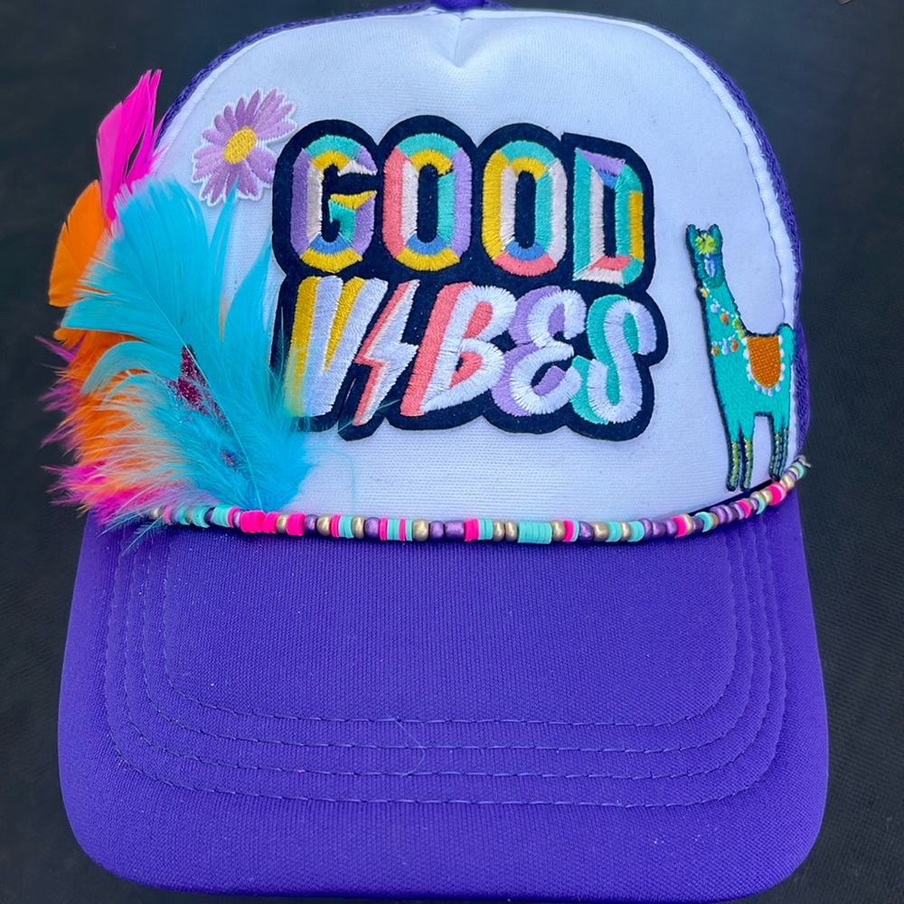 Custom Trucker Hat with beads, patches and feathers. Spot clean only.